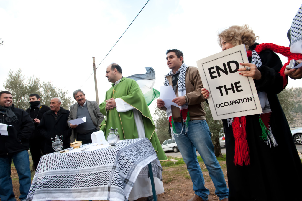 Palestinians hold a Catholic mass as a nonviolent protest against the Israeli Separation Wall in the West Bank town of Beit Jala, February 10, 2012.